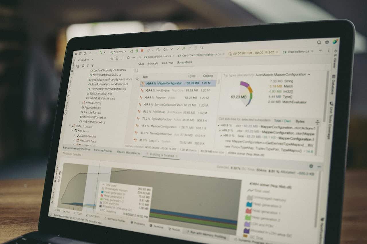 A close-up view of a laptop screen showing a coding and data analysis software interface in an indoor setting.