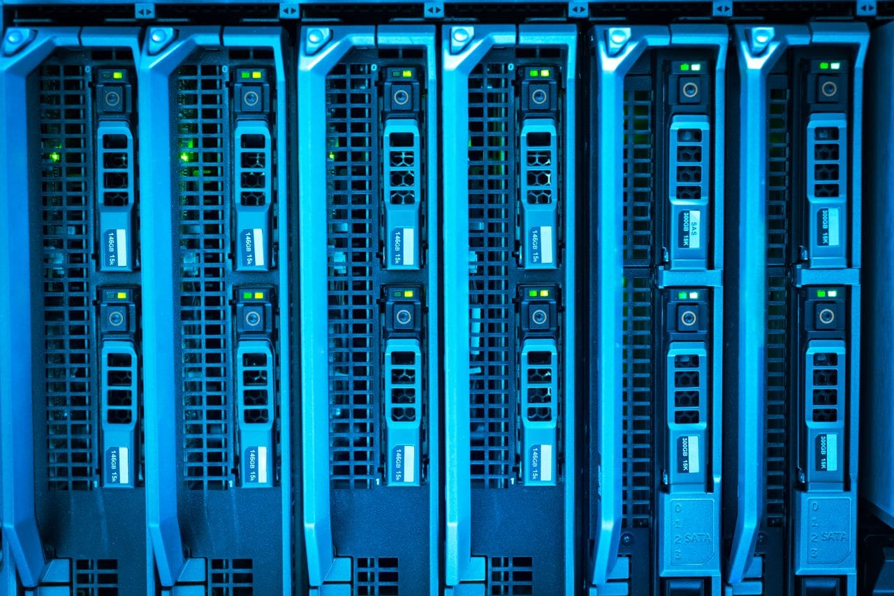 services-02 Detailed image of illuminated server racks showcasing modern technology infrastructure.